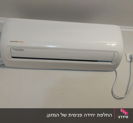 מזגן קיר לבן עם כבל חשמל מחובר